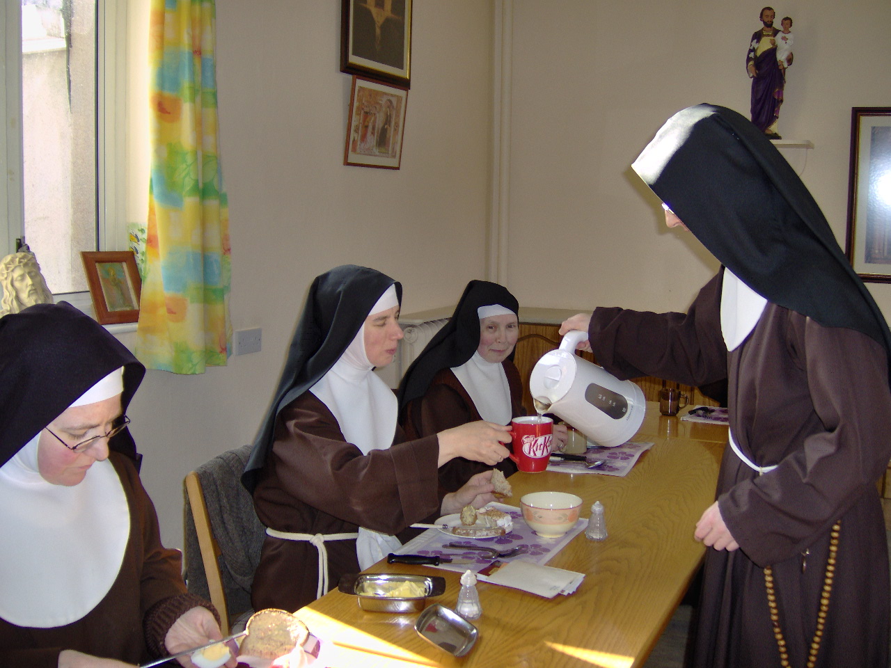 A Sister pours out a drink